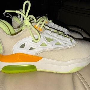 Jordan’s White and Neon Green Sneakers with Orange Accents